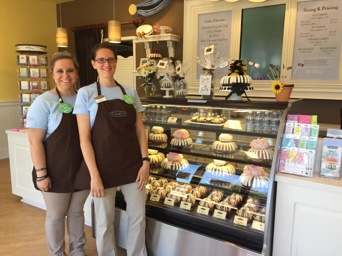 Team members and cake display at Nothing Bundt Cakes in West Lafayette
