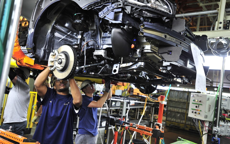Subaru of Indiana Automotive associates working on a vehicle assembly line