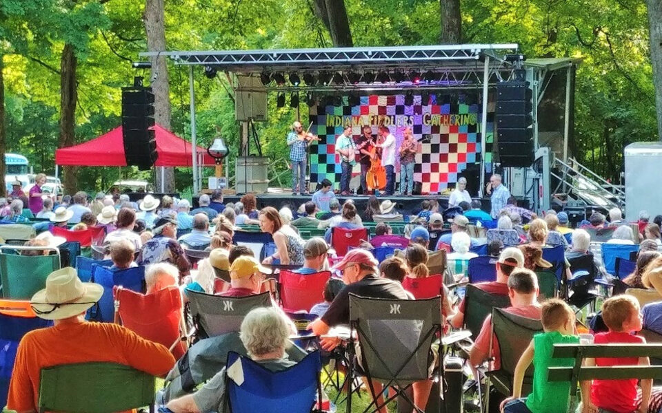 Audience gathered under the trees at the Indiana Fiddlers' Gathering